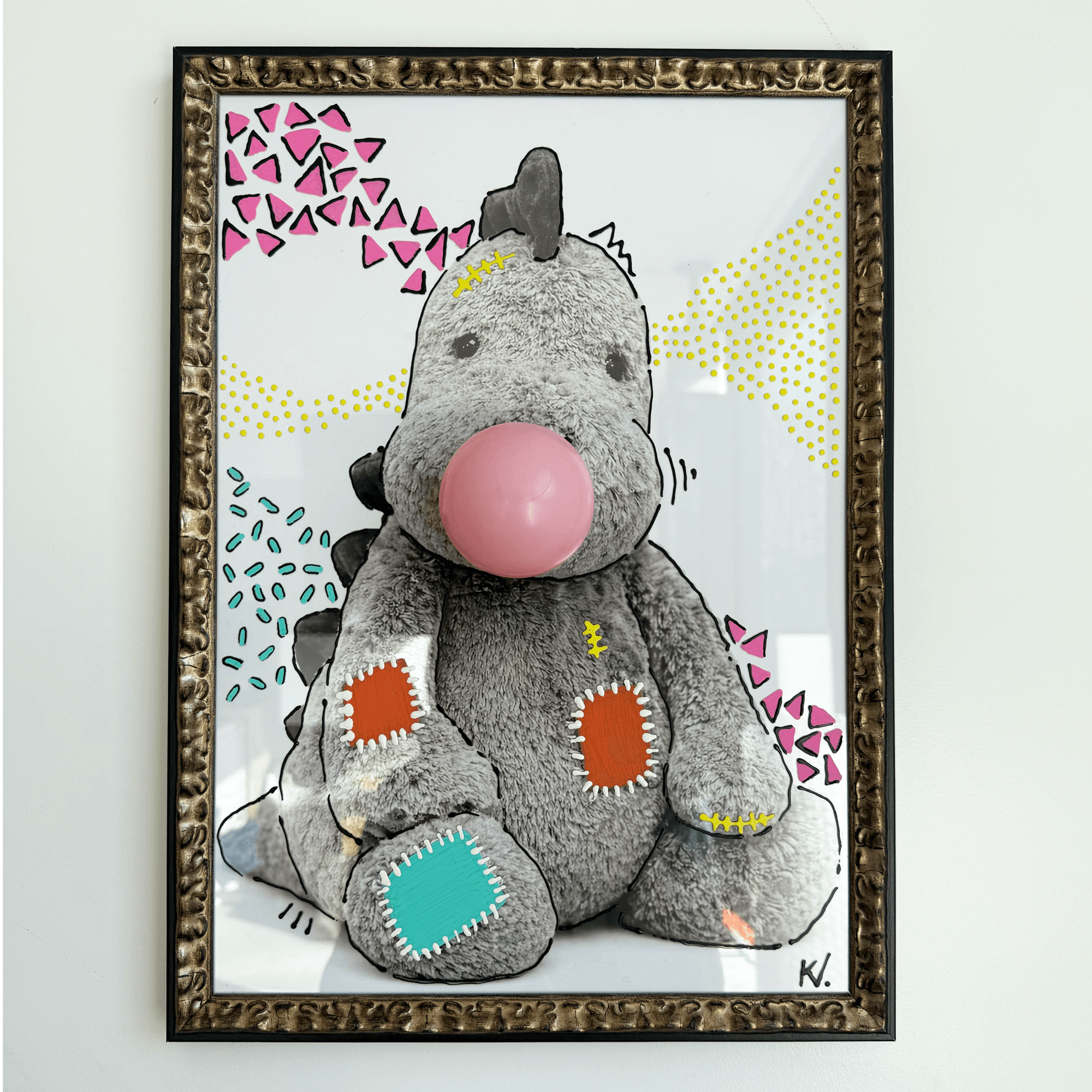 Frontal view of "Cute Dino" (2026): recycled ball-pit ball and print with acrylic paint in a slim wooden frame.